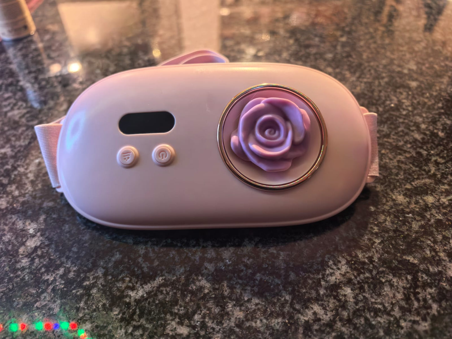 Front view of pink heating belt with rose-shaped warming panel
