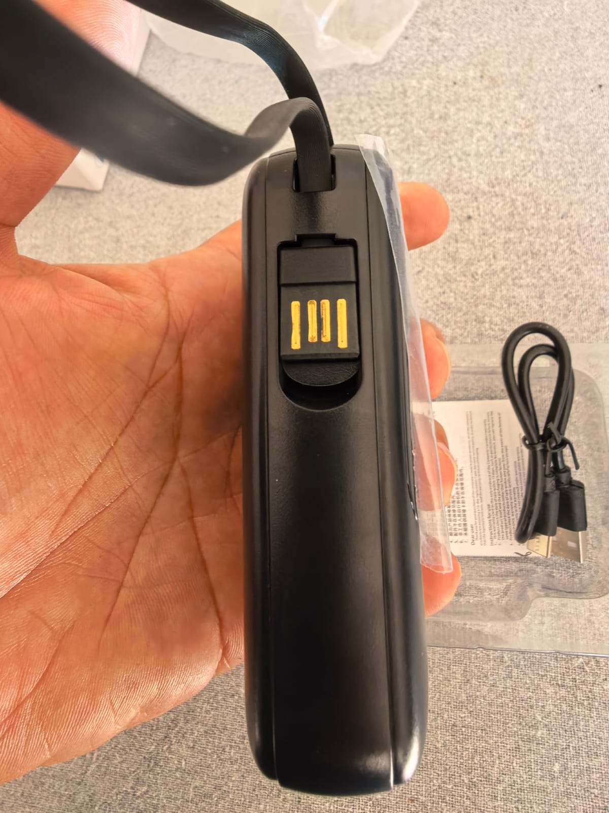 Integrated fold-out USB charging connector on the power bank