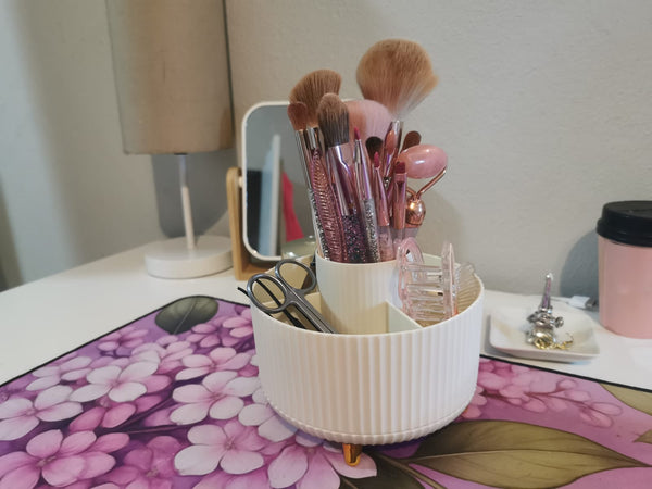 Cream 360-degree rotating makeup organiser holding brushes and beauty tools