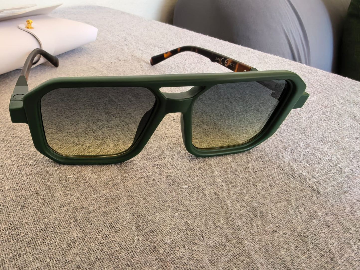 Close-up of green square UV400 sunglasses