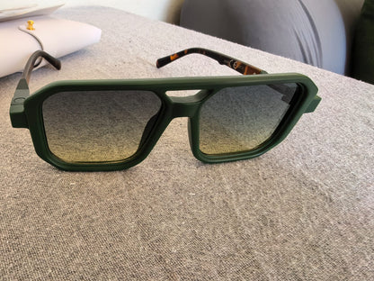 Close-up of green square UV400 sunglasses